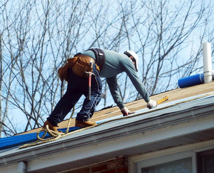 Handyman working on repairing the roof