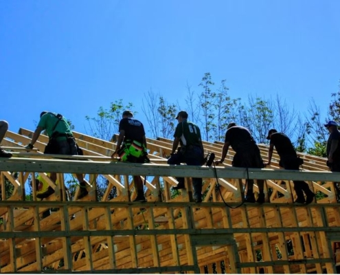 Professional commercial roofing San Antonio installation team working on large business building
