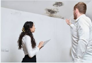 San Antonio homeowner documenting water damage for insurance claim with Prime Time guidance