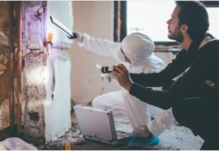 7 Essential Things to Know About Water Restoration Companies in San Antonio 2 Water restoration companies technician using moisture detection equipment in San Antonio home