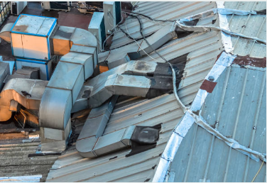 Commercial Roofing Water Damage Restoration Solutions 4 Commercial roofing maintenance showing damaged membrane and equipment-related water damage in San Antonio