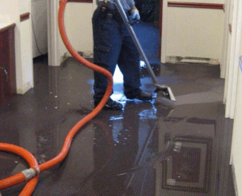 Water damage restoration Dallas emergency response team extracting flood water from residential property