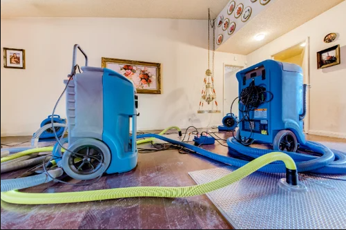 Professional water damage restoration San Marcos TX equipment removing moisture from flood-damaged home