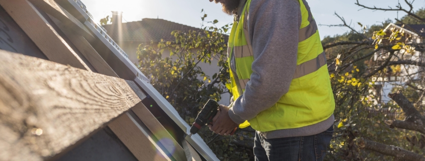 5 Proven Ways to Upkeep a Commercial Roof in San Antonio, Texas (and Avoid Costly Repairs) 1 man working roof with drill min