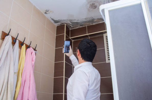 Emergency Water Damage Restoration: The 5-Step Response Every Homeowner Needs to Know 3 Homeowner documenting emergency water damage restoration evidence for insurance