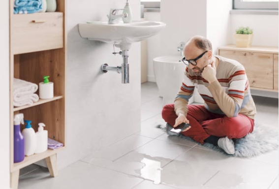 Why 24/7 Restoration Services Matter When Disaster Strikes Your Home or Business 4 Homeowner documenting water damage for insurance while 24/7 restoration team begins cleanup in Texas home