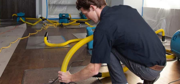 Water Mitigation Services Explained: What They Are and Why You Need Them Immediately 1 water mitigation services technician extracting floodwater from a residential property